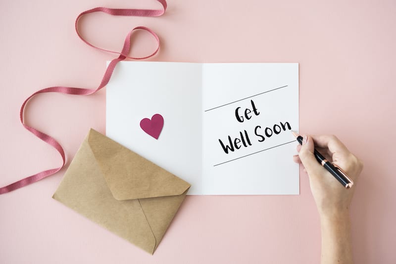 get well wishes mood photo hand writing a card with ribbon