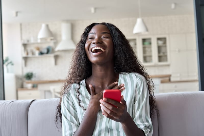 good morning messages for her black african woman laughing on sofa