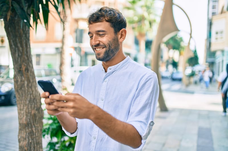 good morning messages for him smiling man texting outside