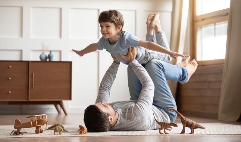 happy fathers day young kid airplaning with dad