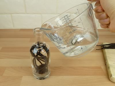 how to make vanilla extract - pouring in the vodka