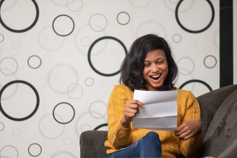 love letters for her woman laughing reading letter