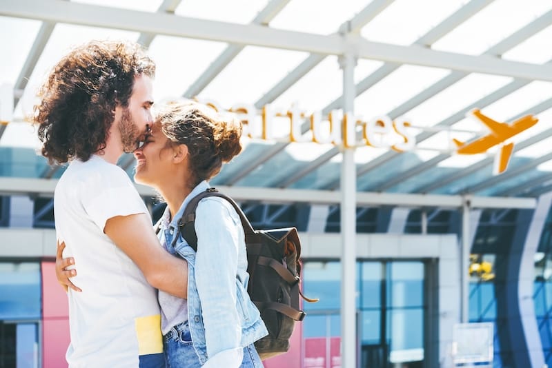 paragraphs for her couple hugging at airport