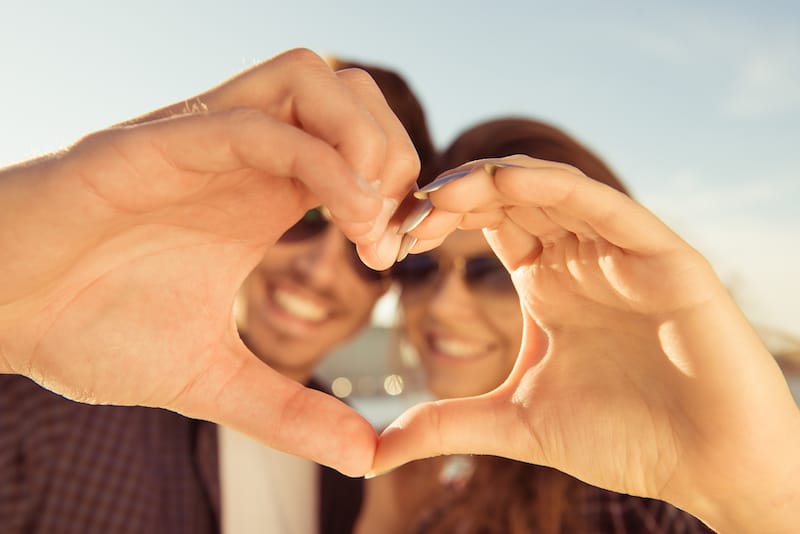 love messages for him couple making heart shape with hands