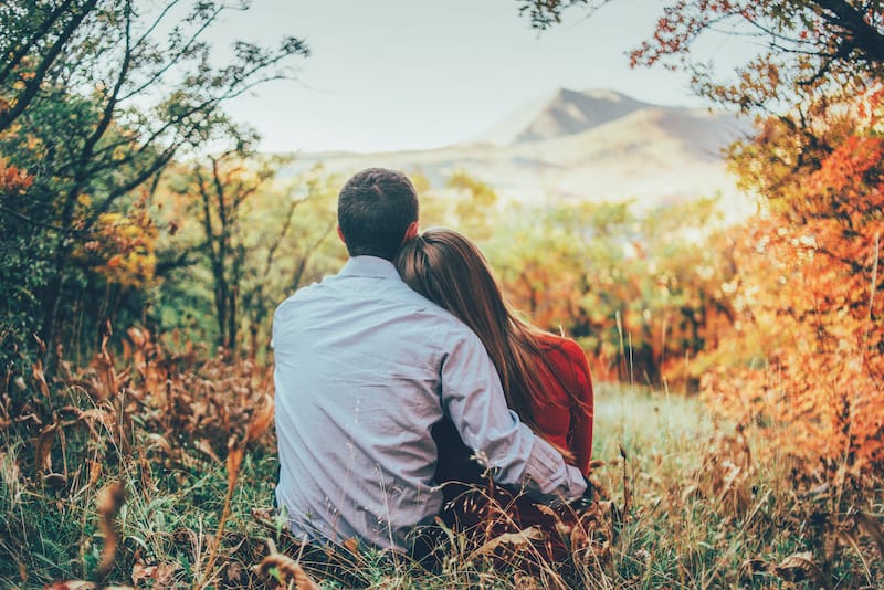 love messages couple sitting together with a pretty landscape