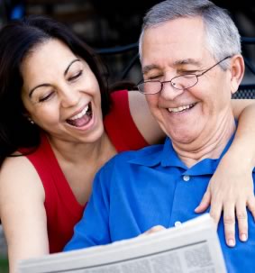 smiling couple looking at generated newspaper